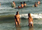 Topless teens in the warm sea water