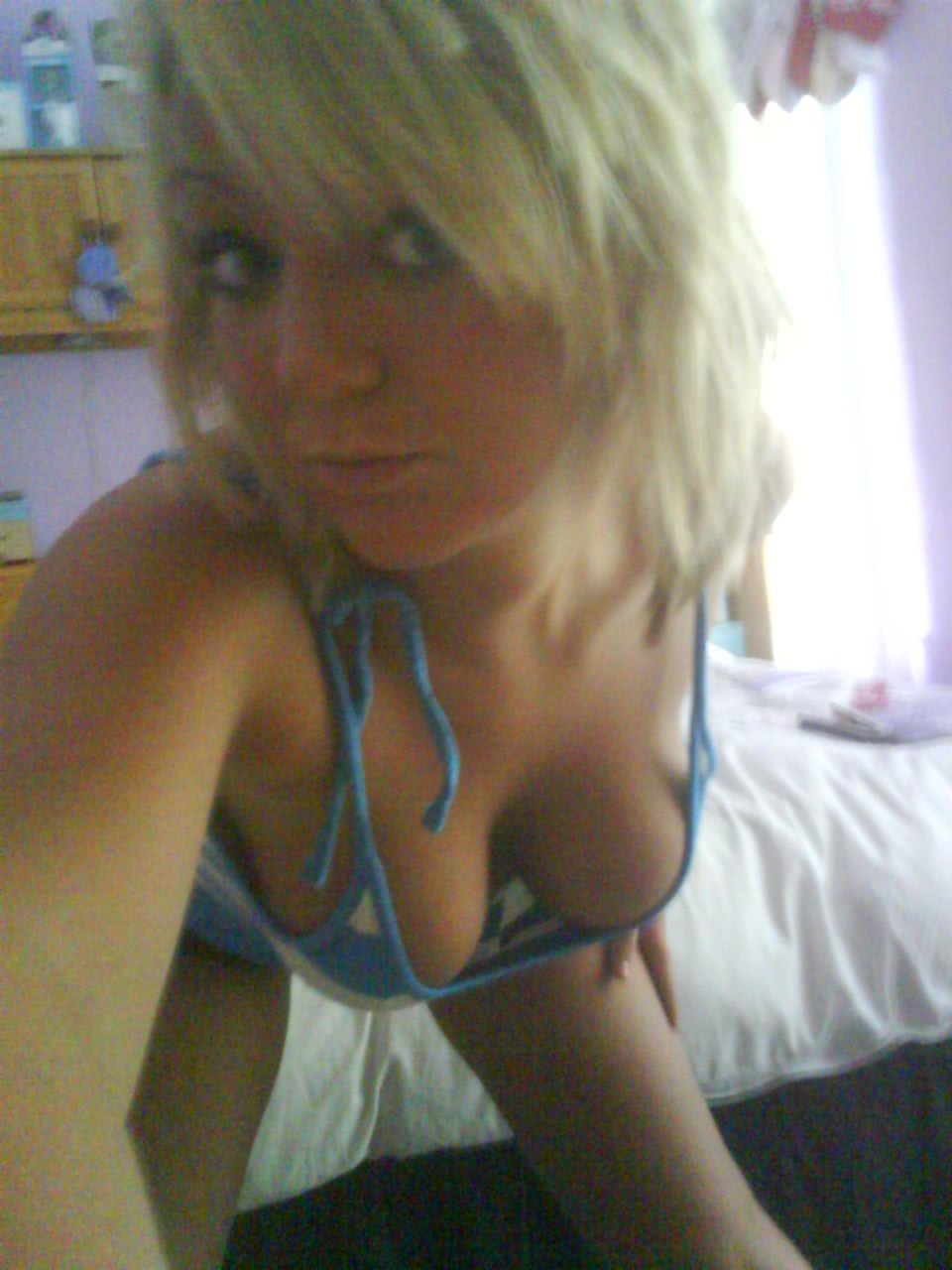 Blonde takes a selfshot of her decolletage