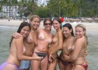 Several teens having fun topless