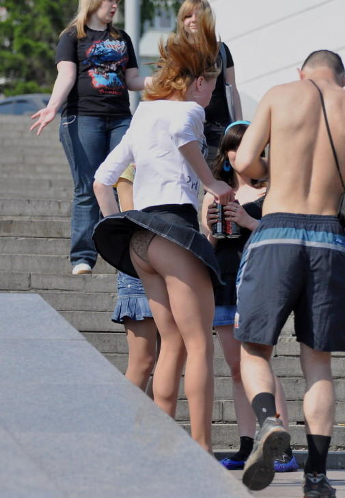 Miniskirt blown by the wind reveals her panties