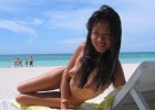 Cute Asian babe naked on the beach