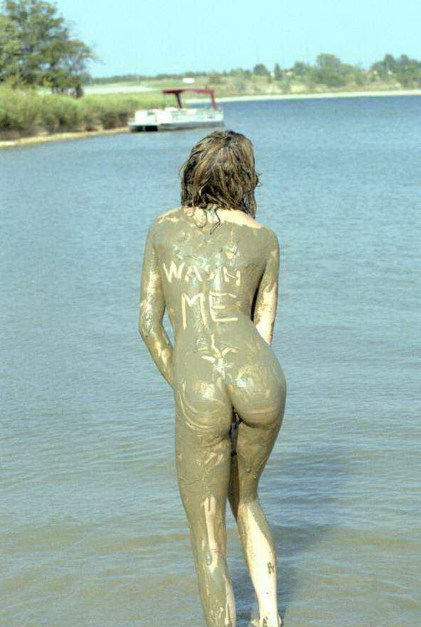 Sexy nude lady covered in mud